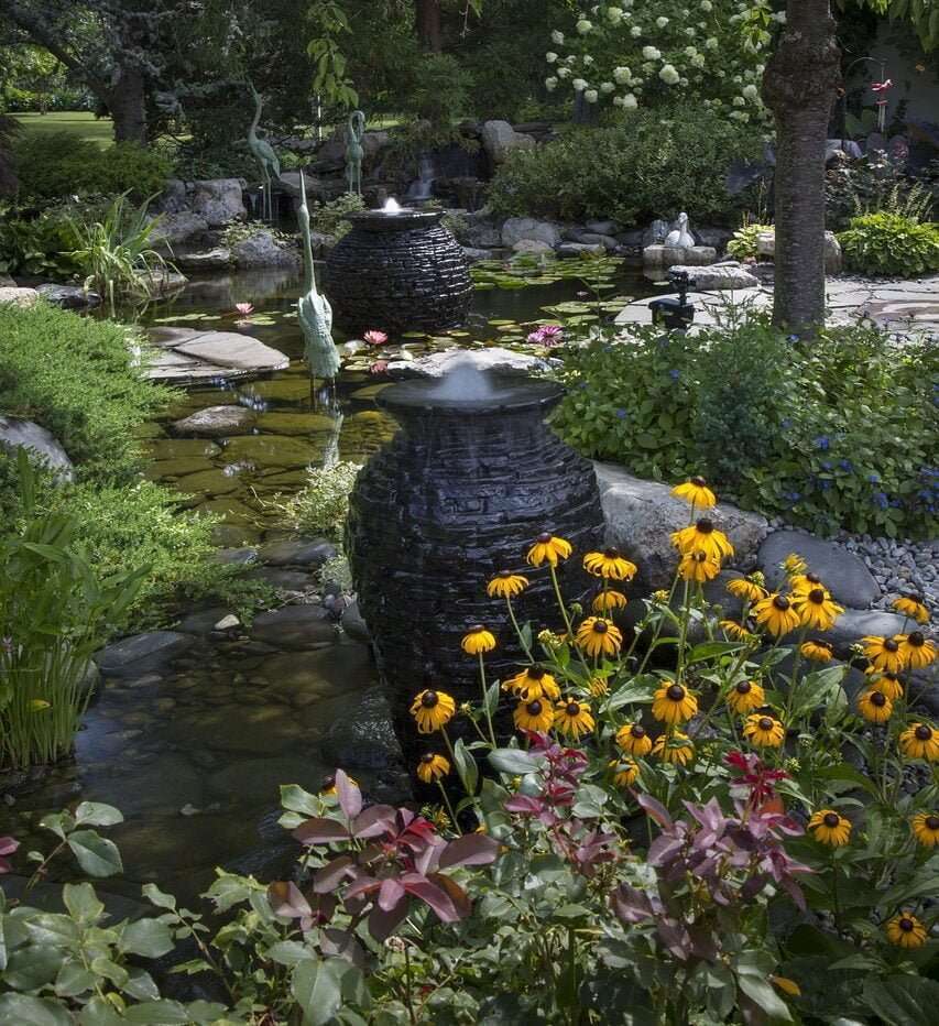 Black Eyed Susans, crane statues, goose, urn fountains